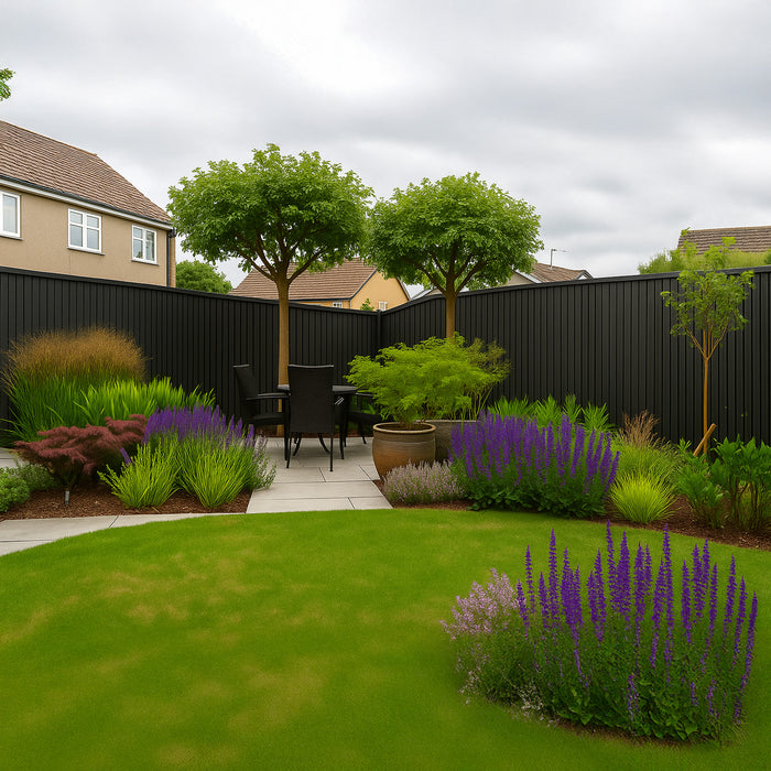 Backyard garden with a patio area, trees, and various plants on a cloudy day. With a feature black slat clad fence