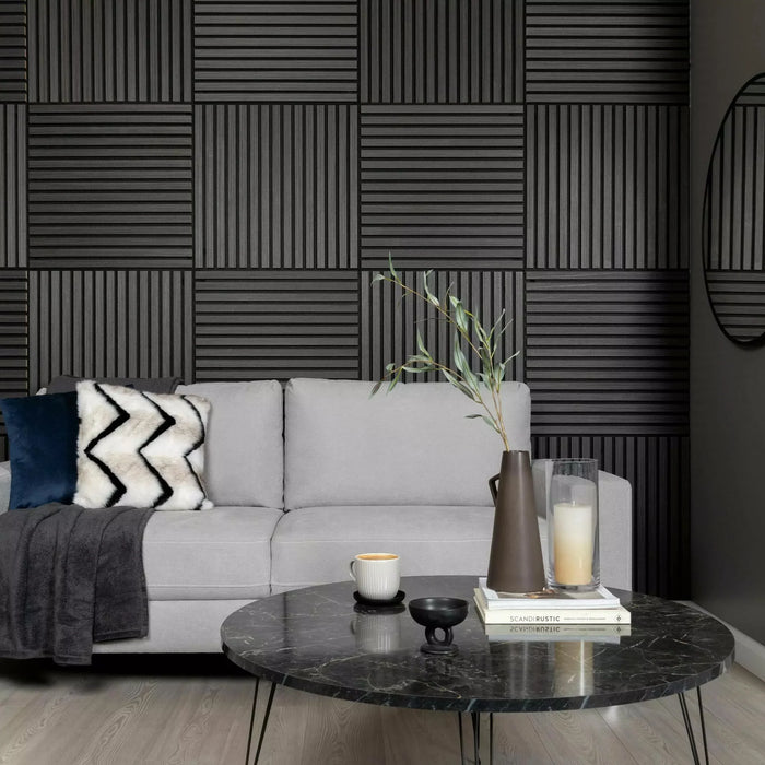 Modern living room with gray sofa, marble coffee table, and decorative wall panels.