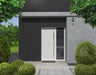 Modern house exterior with a white door and black slatted cladding and gray walls, surrounded by greenery.