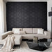 Modern living room with a hexagonal black wall pattern and a beige sectional sofa.